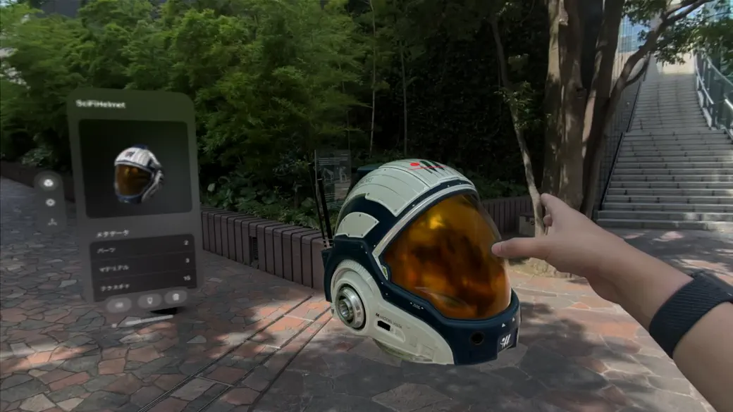 Model Vista displaying an interactive helmet model in mixed reality on Apple Vision Pro
