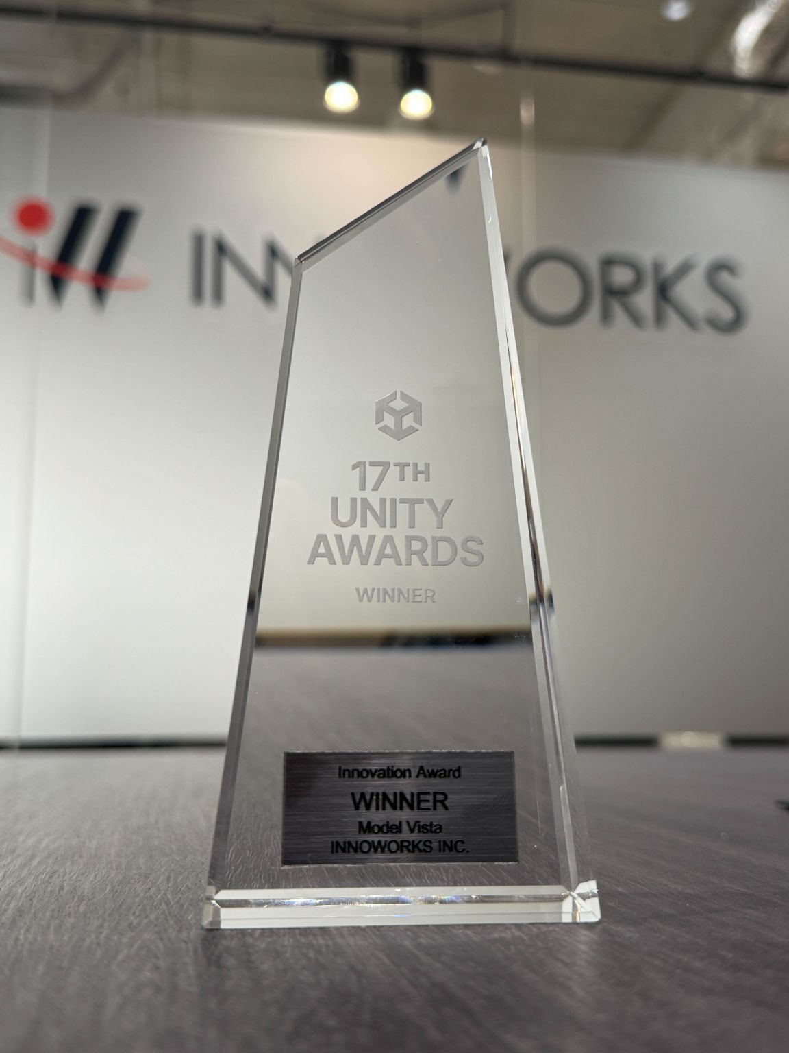 Model Vista’s Unity Innovation Award trophy in front of the INNOWORKS logo